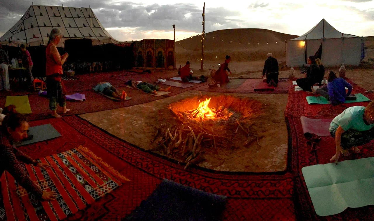 Desert camp beside the Sahara dunes at sunset