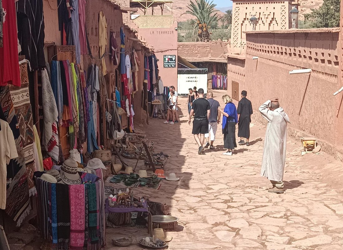 Travelers walking through a southern Morocco village
